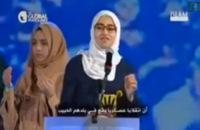بالفيديو.. فتاة ترفع "رابعة" في مؤتمر عالمي.. وتحكي قصة الانقلاب ومجازره