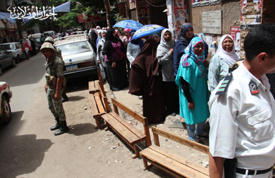 ناخبات المعادي يواجهن الحر بالشماسي وزجاجات المياه